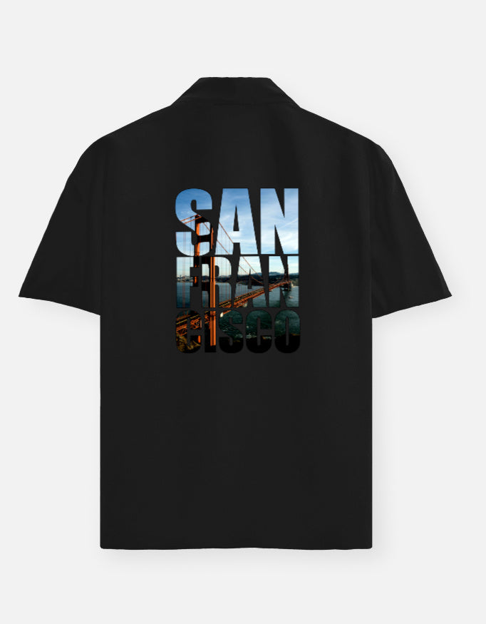 Black polo shirt with 'San Francisco' text and bridge graphic on the back against a white background