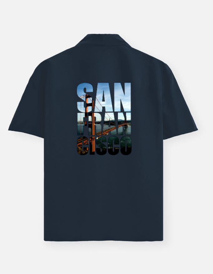 Black polo shirt with 'San Francisco' text and bridge graphic on the back against a white background