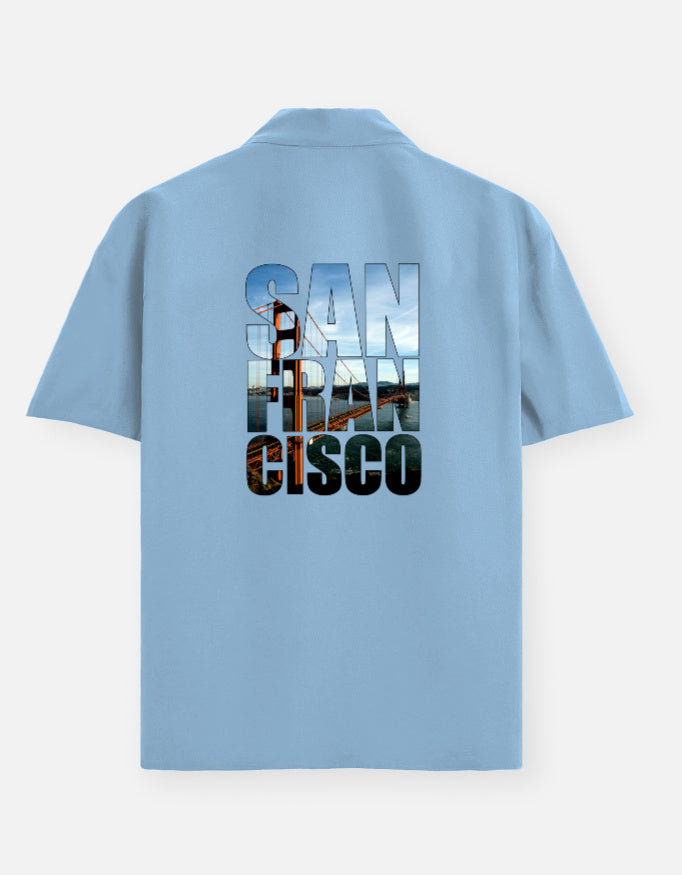 Light blue polo shirt with 'San Francisco Cisco' text on the back against a white background