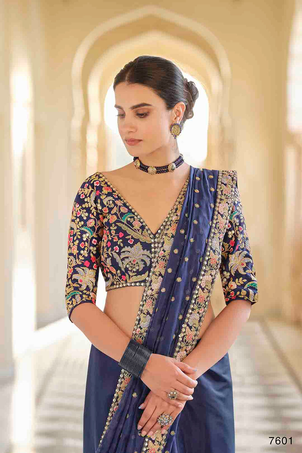 Woman wearing a traditional embroidered organza saree & non stitched Art Silk Blouse.