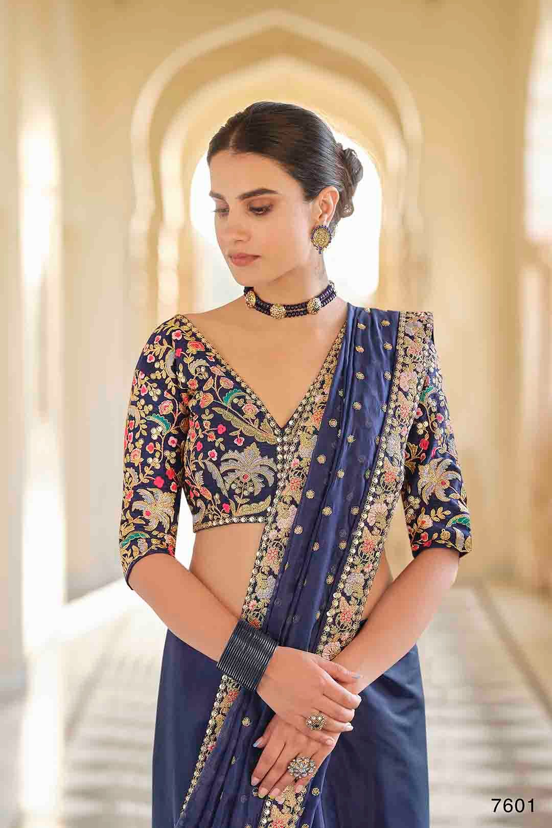 Woman wearing a traditional embroidered organza saree & non stitched Art Silk Blouse.