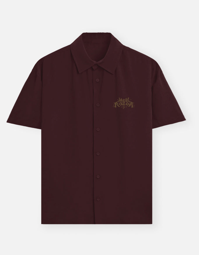 Maroon shirt with an owl emblem on a light gray background