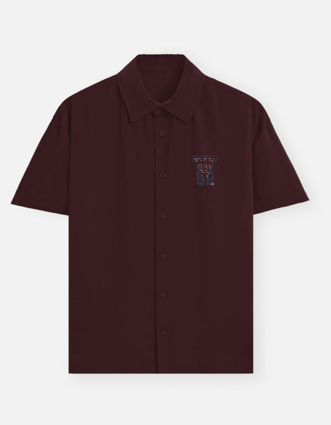 Maroon shirt with colorful text on a white background