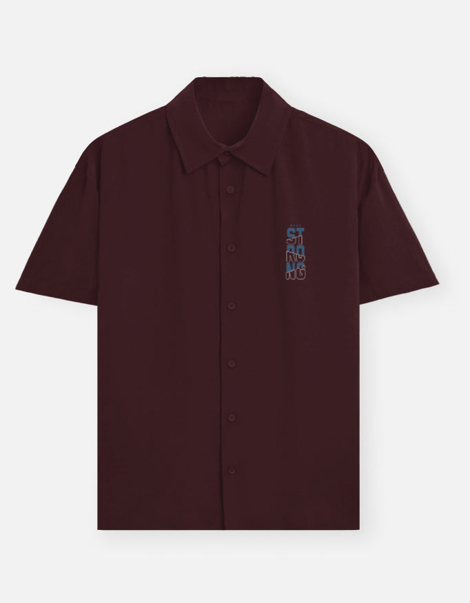 maroon shirt with colorful text.
