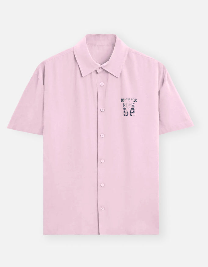 Pink shirt with a small graphic on a light gray background