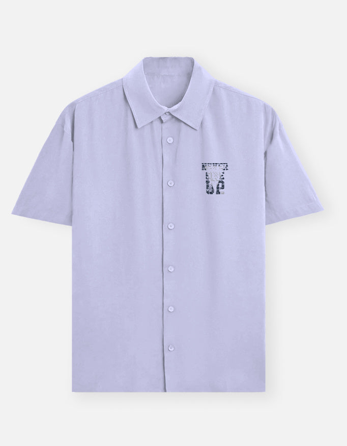 Light blue shirt with a small emblem on a white background