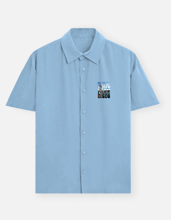 Light blue shirt with a colorful logo on the chest against a white background
